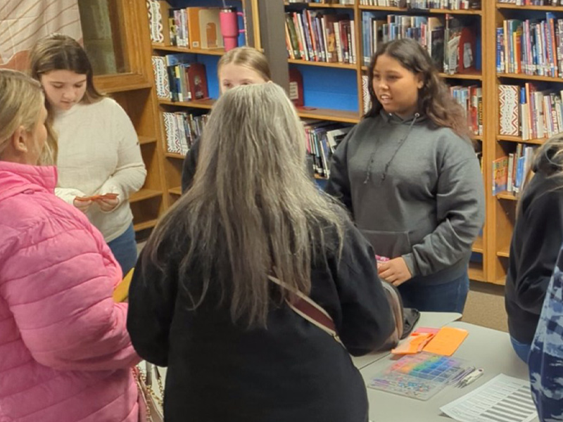 A group of students in an open market simulation.